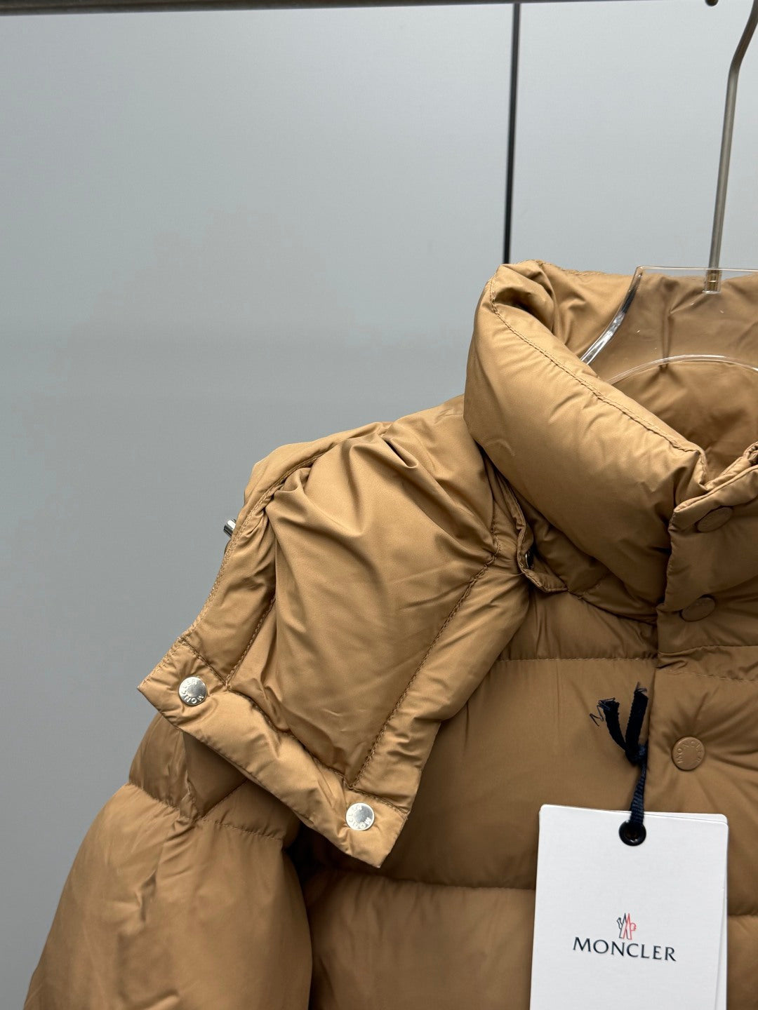 Moncler long puffer jacket in tan with ribbed cuffs and snap buttons