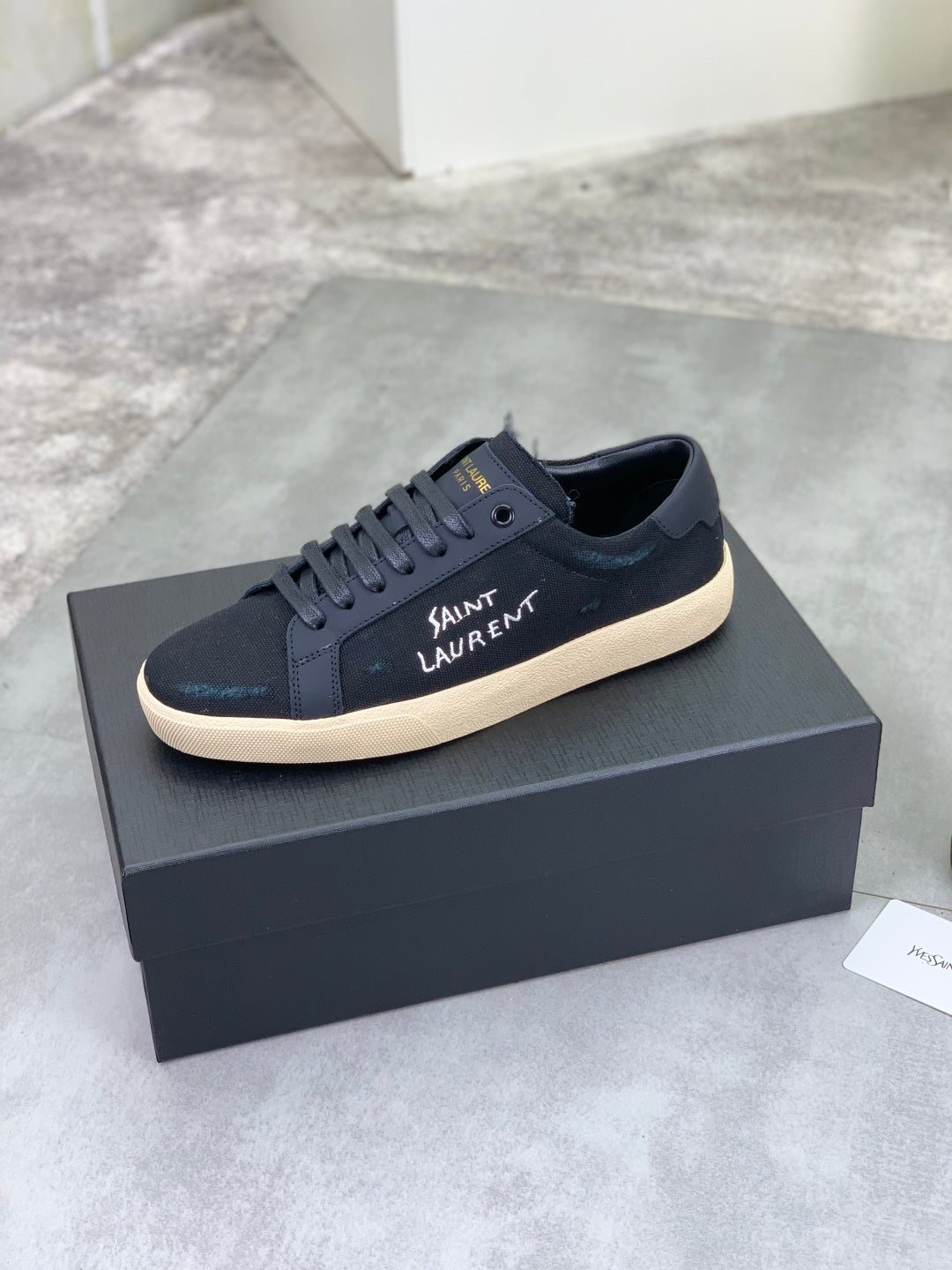 Navy SAINT LAURENT sneakers on a box, lace-up with beige rubber sole