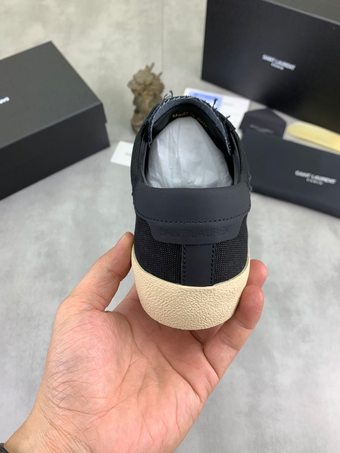 Navy SAINT LAURENT sneaker back view with cushioned collar and beige sole