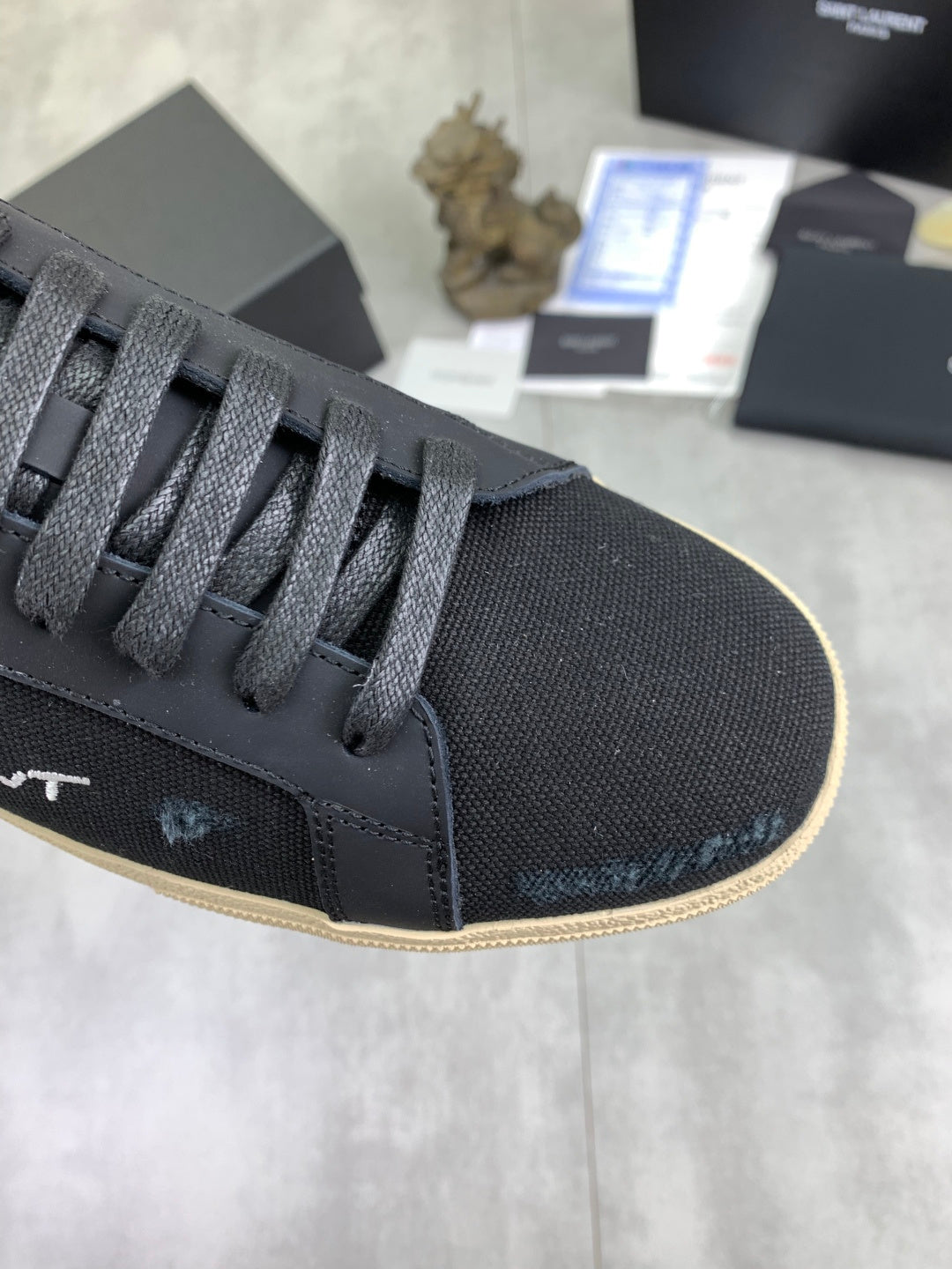 Navy SAINT LAURENT sneaker toe with lace-up eyelets and textured canvas