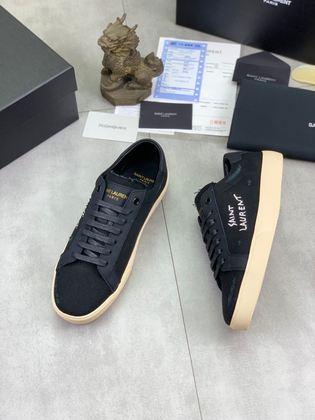 Navy SAINT LAURENT low-top sneakers with lace-up front and beige platform sole