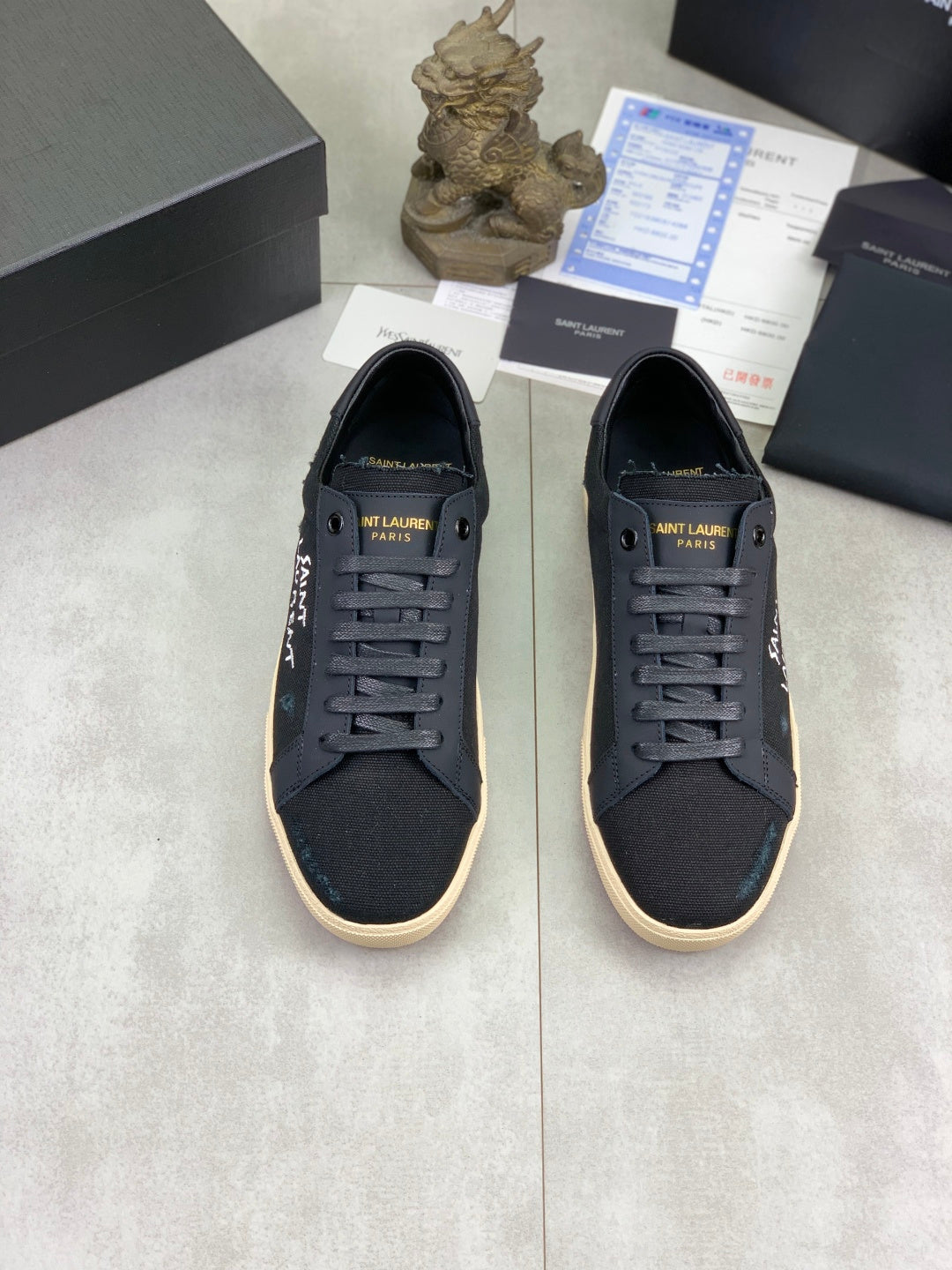 Pair of navy SAINT LAURENT lace-up sneakers with beige soles and side logos