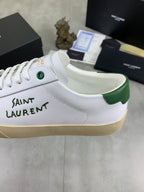 White sneaker upper with green collar lining and SAINT LAURENT lettering.