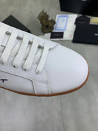 White leather sneaker upper with lace-up front and brown rubber sole