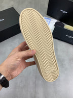 YSL unisex sneakers outsole, beige rubber sole with chevron tread pattern.