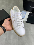YSL unisex sneakers, white leather upper with white laces and tan gum sole.