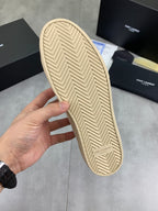 Beige sneaker outsole with textured herringbone tread and Saint Laurent mark