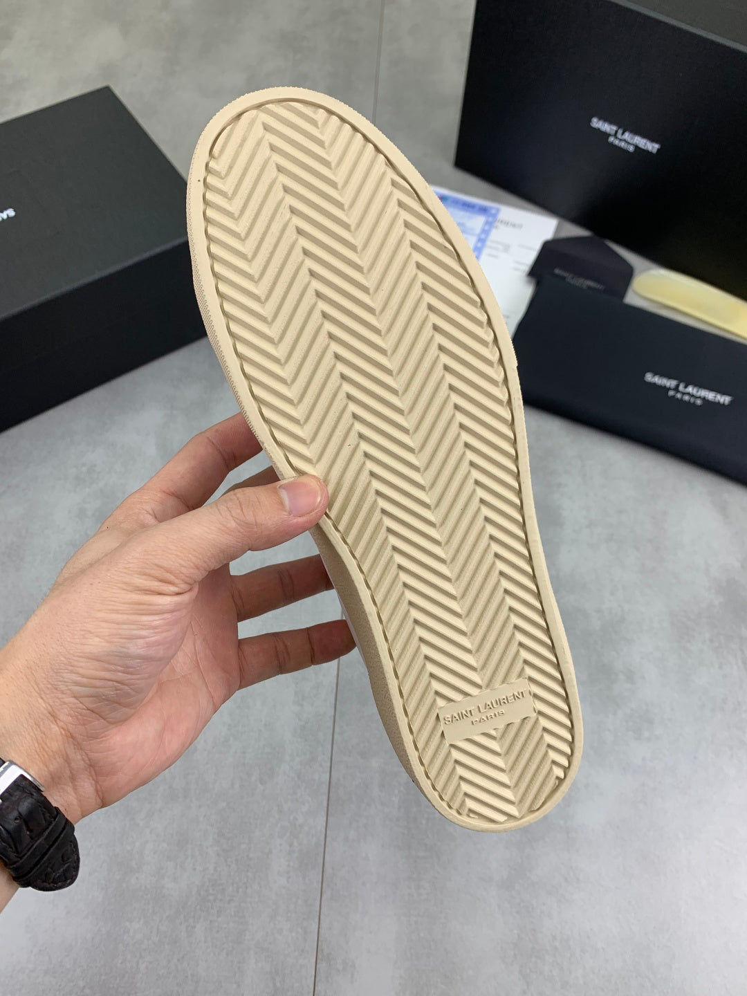 Beige sneaker outsole with textured herringbone tread and Saint Laurent mark