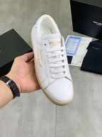 White low-top sneaker with lace-up front, beige rubber sole, and Saint Laurent logo