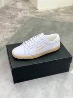 White leather low-top sneaker with lace-up closure and beige rubber sole