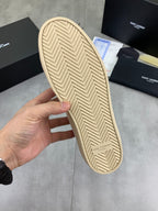 Shoe outsole of white low-top sneaker, beige rubber with herringbone tread