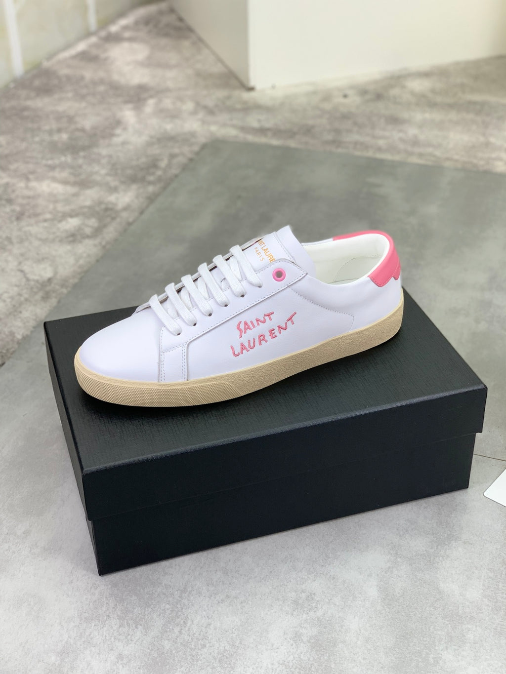 YSL unisex sneakers, white low-top with pink logo patch on side, on box