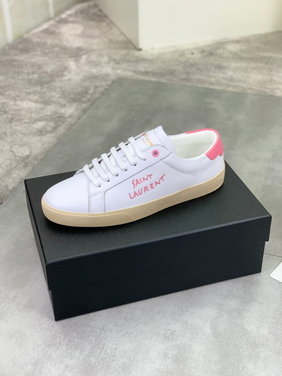 YSL unisex sneakers, white low-top with pink logo patch on side, on box