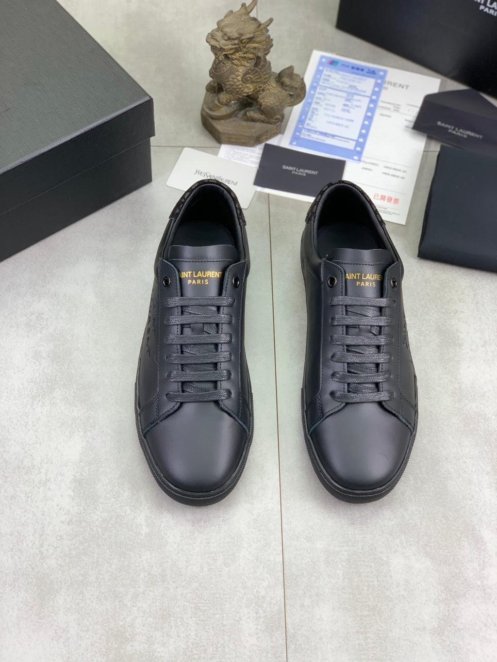Pair of dark navy leather lace-up sneakers with stitched logo detail.