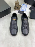 Pair of dark navy leather lace-up sneakers with stitched logo detail.