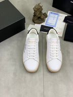 Saint Laurent unisex low-top sneakers pair, white uppers with beige gum soles