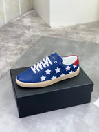 Blue low-top sneakers with white stars, red collar trim, beige rubber sole