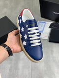 Blue low-top sneakers with white star panels, white laces, beige rubber sole