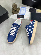 Blue low-top sneakers with white star pattern and white laces, beige platform sole