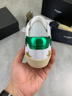 Unisex low-top sneakers heel view: green metallic collar with star accents on white