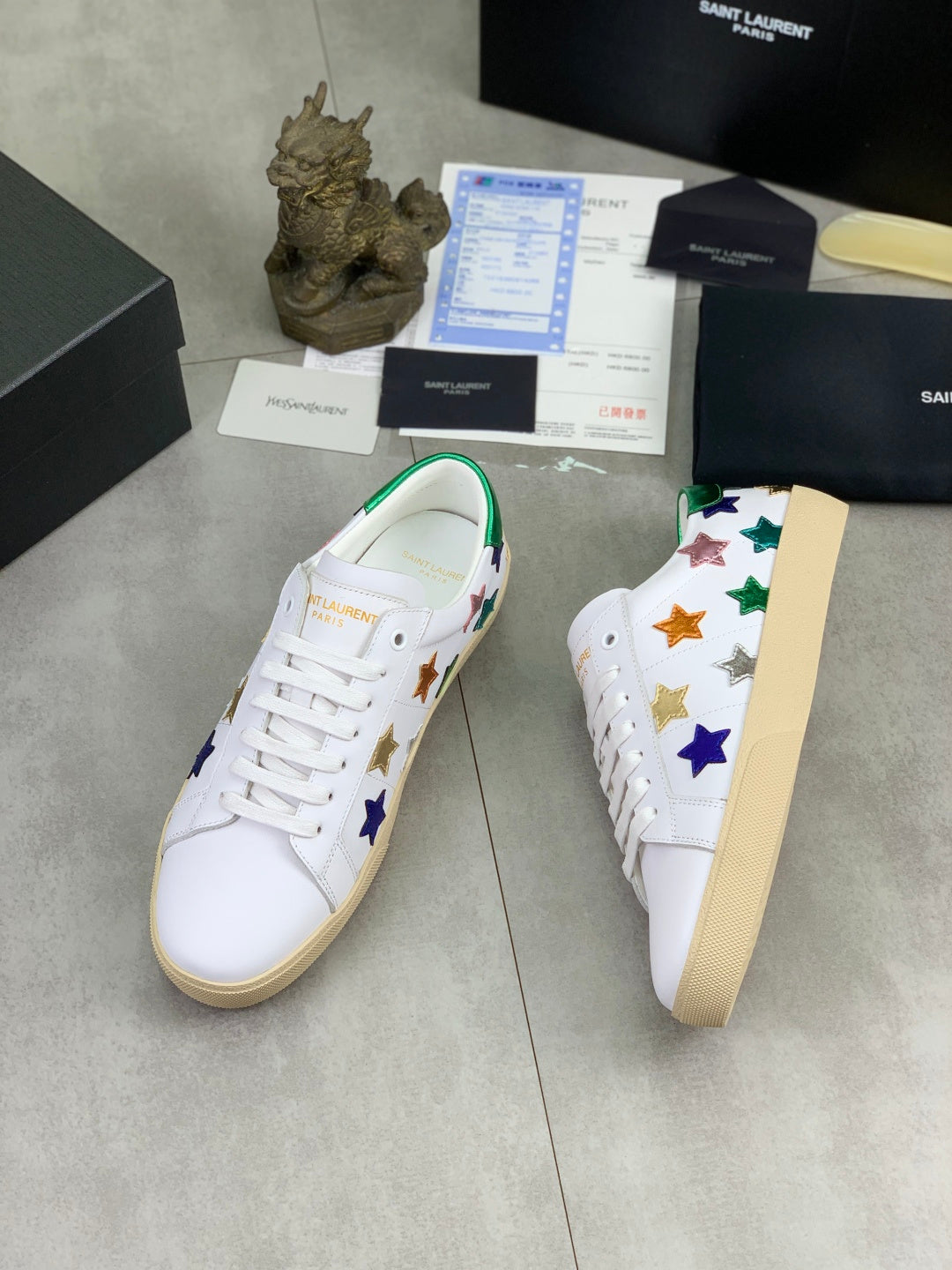 Unisex low-top sneakers with side star embroidery in gold, blue, and green on white