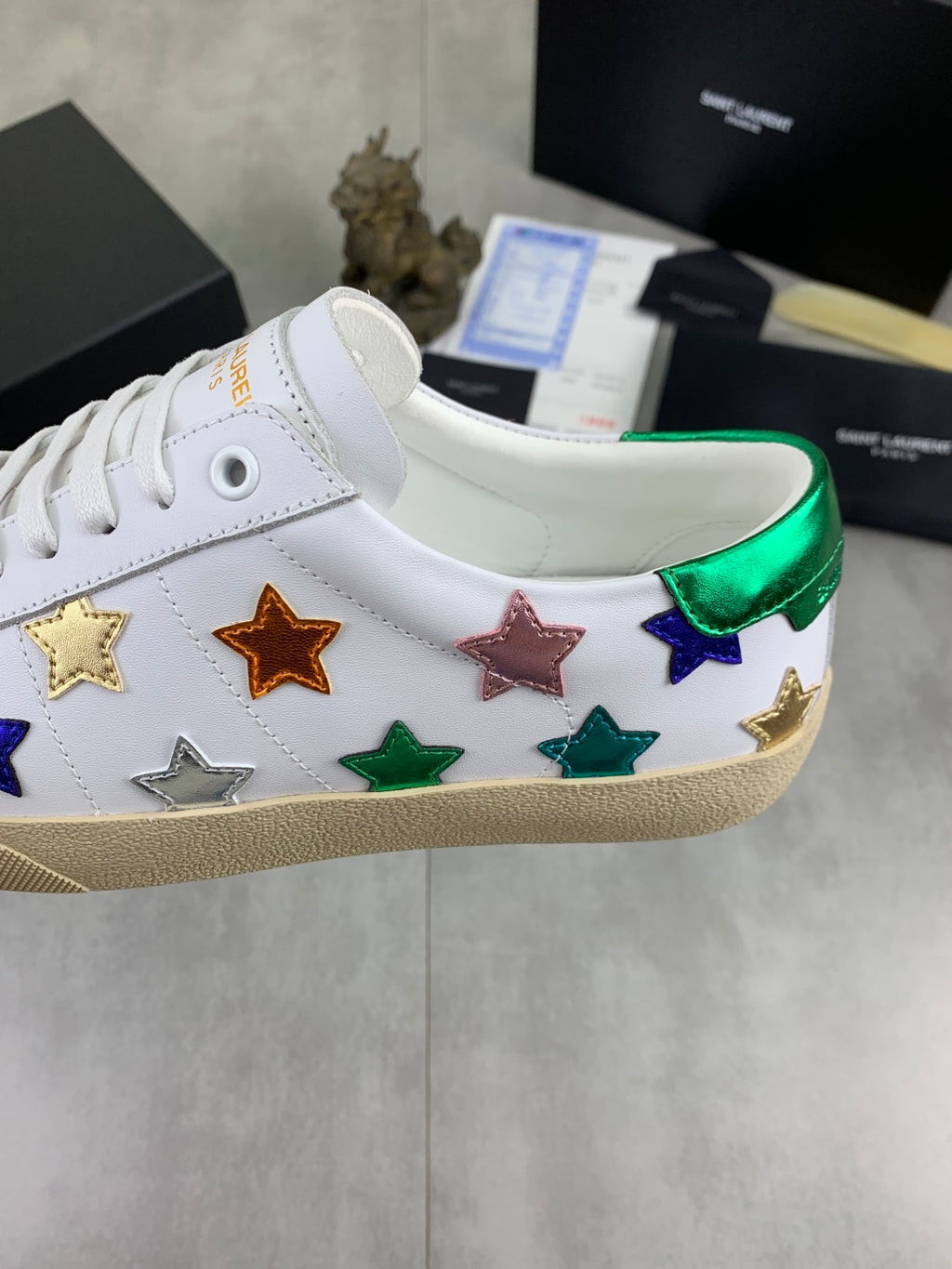 Unisex low-top sneakers side view: colorful star pattern on white, gum sole