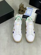 Pair of unisex low-top sneakers with white uppers and colorful star decorations, gum sole