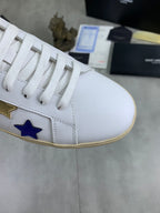 Unisex low-top sneakers close-up: white laces with gold and blue star accents