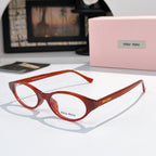 MiuMiu eyeglasses with red frame and clear lenses, round oval front view
