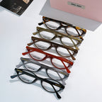 Set of MiuMiu eyeglasses with mixed frames, clear lenses shown stacked