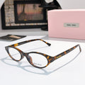 MiuMiu eyeglasses with dark tortoiseshell frame and clear lenses, round oval front view