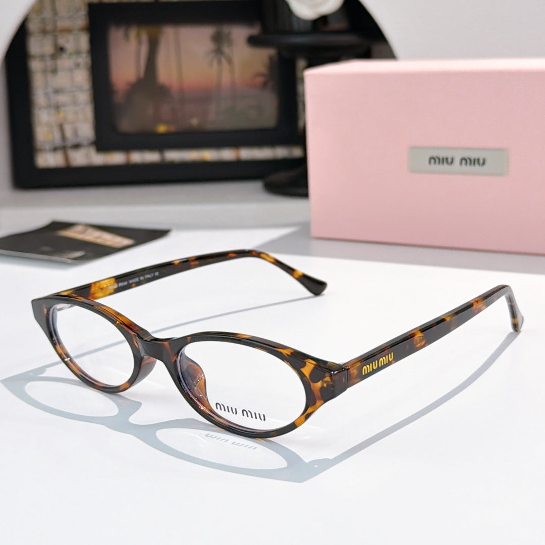 MiuMiu eyeglasses with dark tortoiseshell frame and clear lenses, round oval front view