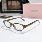 MiuMiu eyeglasses with brown and dark patterned frame and clear lenses, round oval view