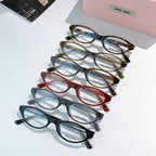 Set of MiuMiu eyeglasses with mixed frames, clear lenses shown in a diagonal stack