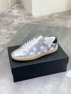 YSL unisex low-top sneakers on box, silver finish with white stars, white laces, gum sole