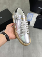 YSL unisex low-top sneakers in silver with white star overlays, white laces, gum sole