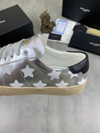 YSL unisex low-top sneakers side view, silver with white stars, black heel tab, gum sole