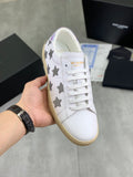 Unisex white sneakers with gray star patches, white laces, and beige rubber sole