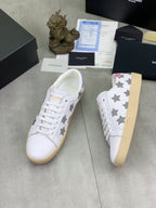 Unisex white sneakers with gray star panels and white lace-up front, side view