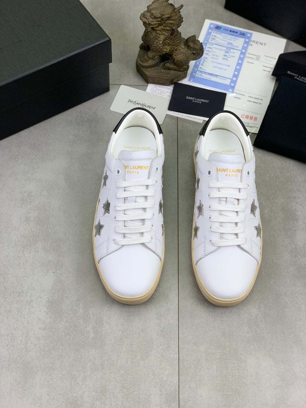 YSL unisex luxury shoes: pair of white lace-up sneakers with star embroidery, tan sole