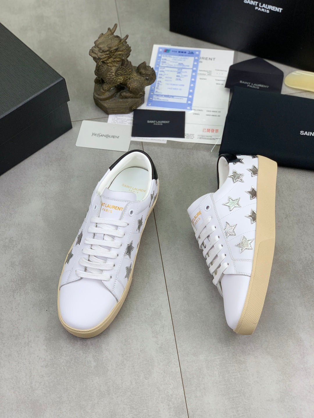 YSL unisex luxury shoes: white low-top sneakers with star pattern, tan rubber sole