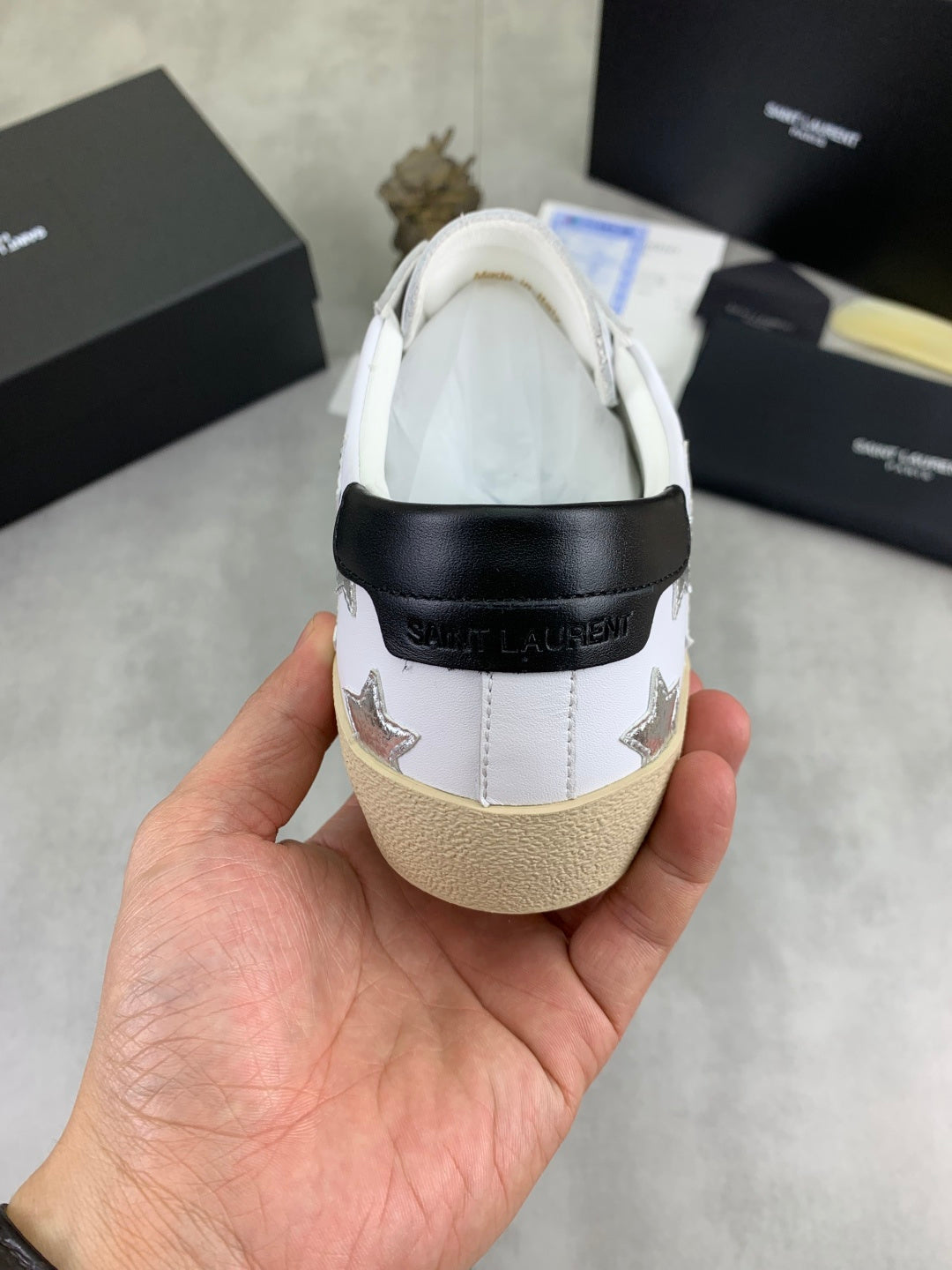 YSL unisex luxury shoes: heel view of white sneaker with black collar and star details