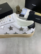 YSL unisex luxury shoes: white sneaker side with metallic stars, black heel tab, tan sole