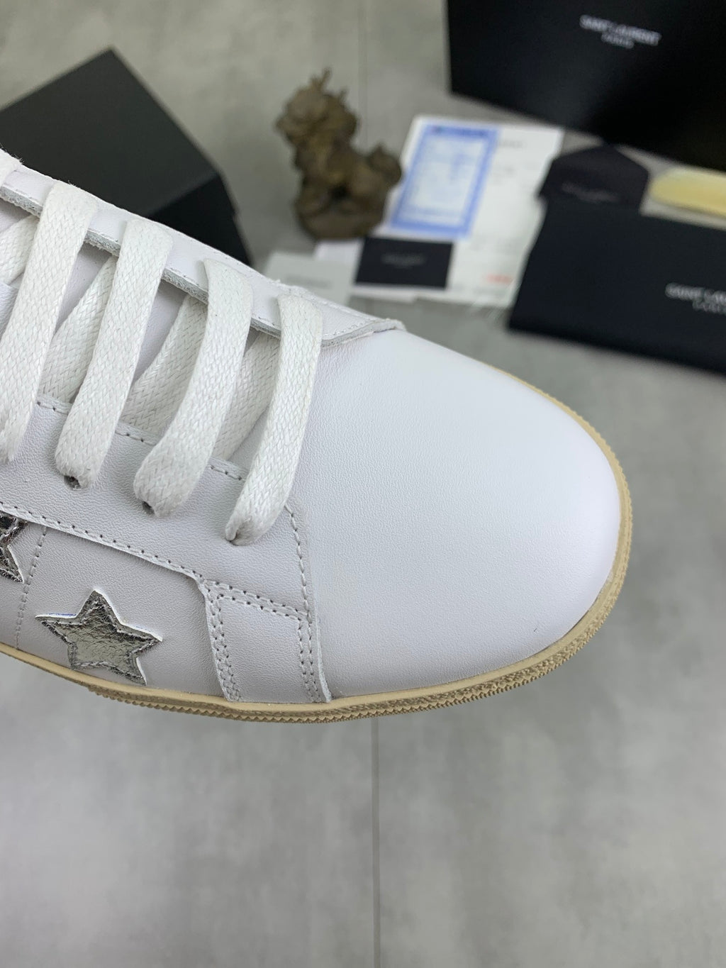YSL unisex luxury shoes: white sneaker toe and side with star emblem, tan edge sole
