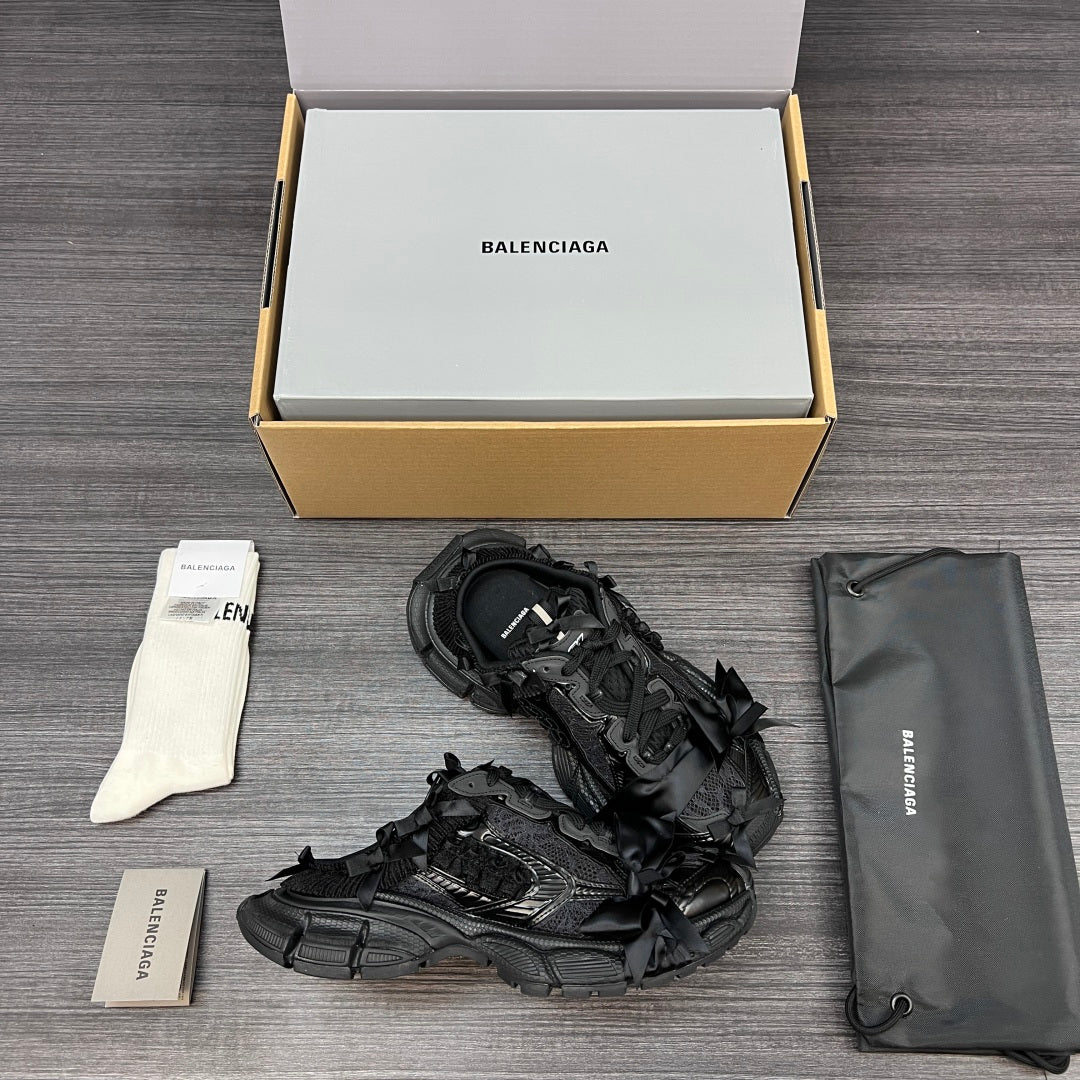 Balenciaga black lace-up sandals showing side profile and textured tread sole