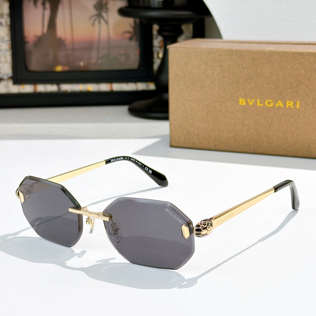 Gold-rimmed sunglasses with gray-tinted lenses and slim angular temples