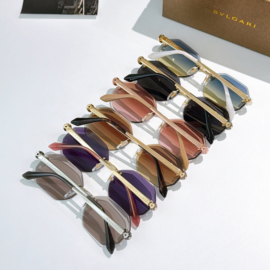 Stack of assorted sunglasses with gold frames and colorful tinted lenses