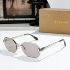Gold-rimmed sunglasses with light pink-tinted lenses and slim angular temples