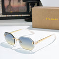 Gold-rimmed sunglasses with blue-tinted lenses and slim angular temples