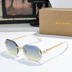 Gold-rimmed sunglasses with blue-tinted lenses and slim angular temples